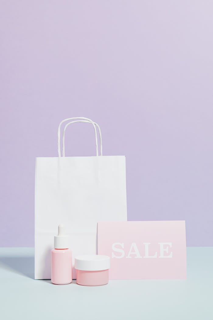 services-03 Elegant beauty product display with sale sign and shopping bag in minimalist style.